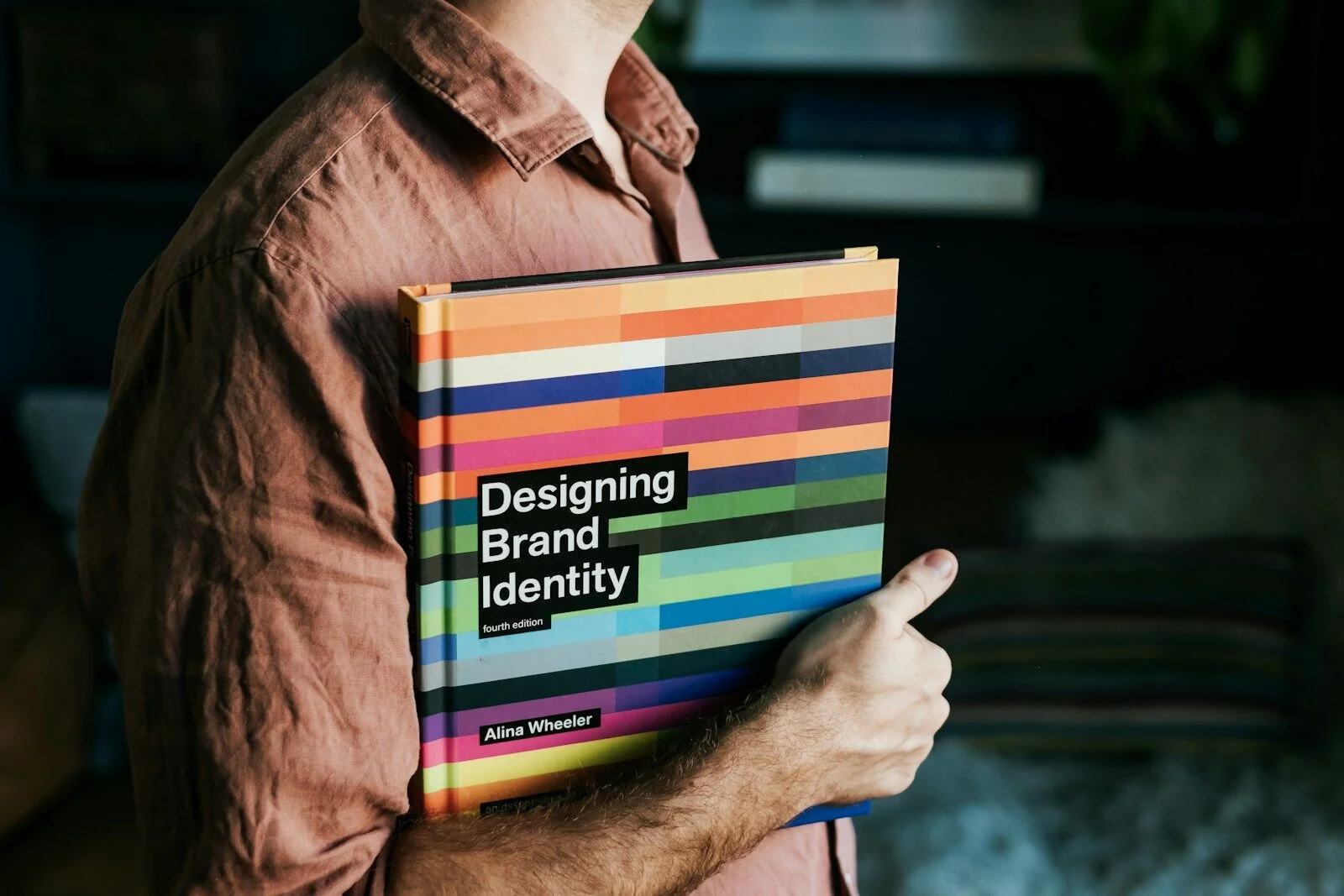 The book Designing Brand Identity, open — a reference on brand guidelines and brand identity