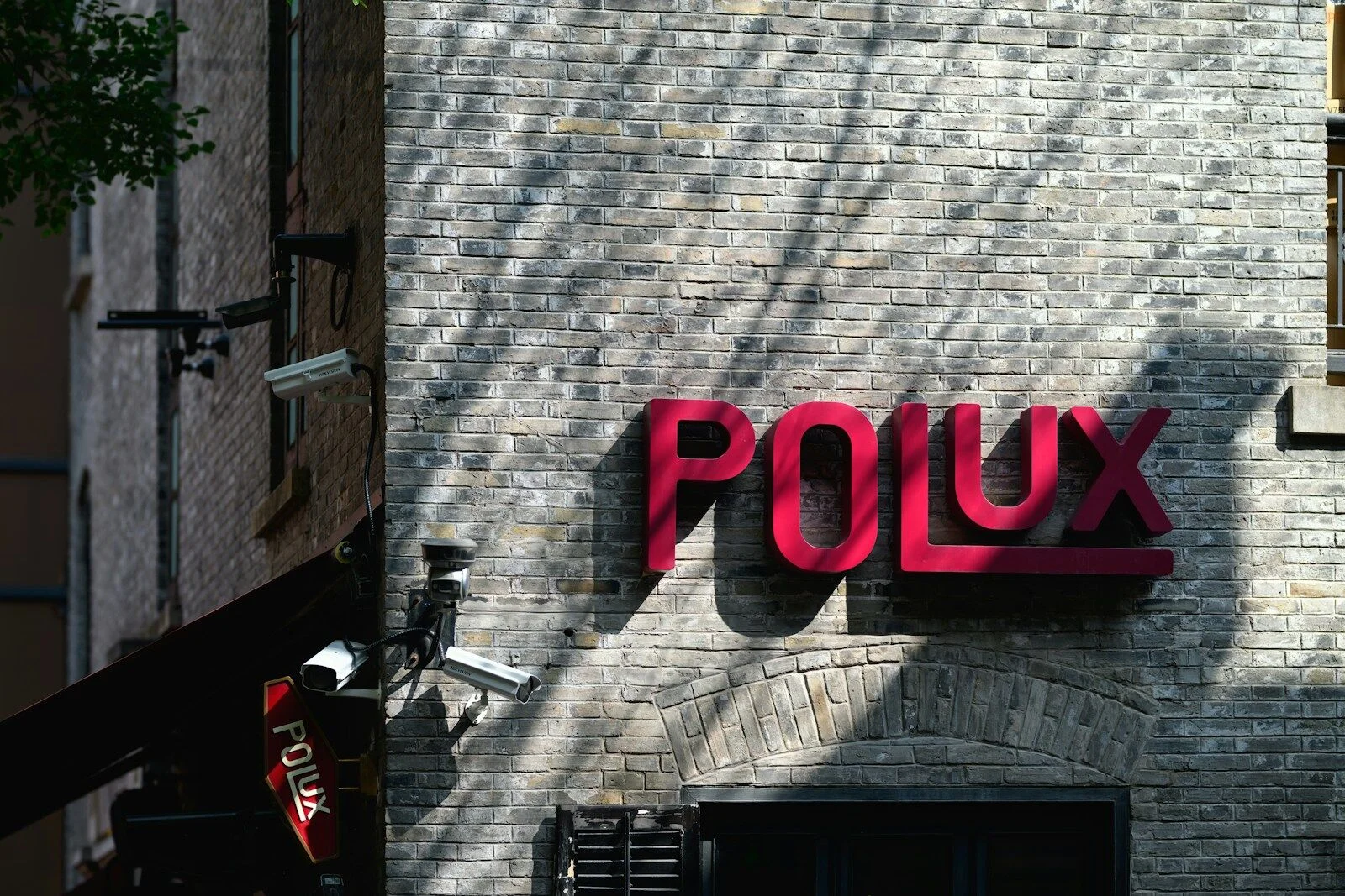 A wall of logos and urban signage — a collection of brands side by side on a facade.